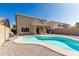 Inviting backyard pool and gravel area for relaxing and a covered patio for entertaining at 3910 W Goldmine Mountain Dr, San Tan Valley, AZ 85144