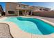 Backyard pool with stone border, spacious patio, and well-maintained landscaping for outdoor enjoyment at 3910 W Goldmine Mountain Dr, San Tan Valley, AZ 85144