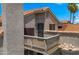 A multi-story exterior showcases a wooden balcony set against a blue sky, highlighting its unique architectural details at 4043 E Mountain Vista Dr, Phoenix, AZ 85048