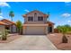 Inviting two-story home displaying an attached garage, low maintenance yard, and tasteful desert landscaping at 4043 E Mountain Vista Dr, Phoenix, AZ 85048