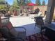Charming back patio with comfortable seating, umbrella-covered table, and a welcoming atmosphere at 42022 W Cheyenne Dr, Maricopa, AZ 85138
