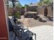 Relaxing backyard with spa, cacti, gravel landscape, and tiled patio at 42022 W Cheyenne Dr, Maricopa, AZ 85138