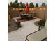 Outdoor patio with dining set, lights, and desert landscaping, perfect for evening gatherings at 42022 W Cheyenne Dr, Maricopa, AZ 85138