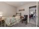 Bedroom with carpet, a floral bedspread, a side table, and a chair at 42022 W Cheyenne Dr, Maricopa, AZ 85138