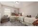 Bedroom features two twin beds, carpeted floors and a window with blinds at 42022 W Cheyenne Dr, Maricopa, AZ 85138