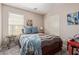 Bedroom with neutral walls, carpet, and a bed with blue pillows and a striped bedspread at 42022 W Cheyenne Dr, Maricopa, AZ 85138