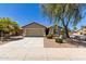 Charming single-Gathering home features a desert-landscaped front yard with a two-car garage and clear blue sky at 42022 W Cheyenne Dr, Maricopa, AZ 85138