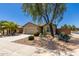 Lovely single-Gathering home featuring desert landscaping with a two-car garage, gravel, cacti and palm tree at 42022 W Cheyenne Dr, Maricopa, AZ 85138