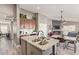 Kitchen island with cabinets, and view of the living and dining area at 42022 W Cheyenne Dr, Maricopa, AZ 85138