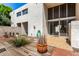 A cozy patio area with an interesting stucco exterior and a sliding glass door entrance to the home at 4648 N 40Th St, Phoenix, AZ 85018