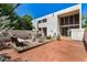 A spacious patio with brick flooring offers a comfortable seating area and a clean stucco wall at 4648 N 40Th St, Phoenix, AZ 85018