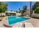 A refreshing community pool surrounded by lounge chairs and lush landscaping at 4648 N 40Th St, Phoenix, AZ 85018