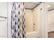 Bathroom shower featuring modern shower curtain, white tile, and brushed-nickel hardware at 4648 N 40Th St, Phoenix, AZ 85018