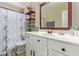 Bathroom featuring a large vanity with a white sink and a decorative mirror and a shower with curtain at 518 S 114Th Ave, Avondale, AZ 85323