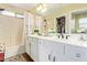 Bright bathroom with a double vanity, bathtub and shower combination, and decorative details at 518 S 114Th Ave, Avondale, AZ 85323