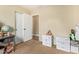 Neutral bedroom with a standard closet with multiple storage options, desk and beige carpet at 518 S 114Th Ave, Avondale, AZ 85323