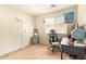 Functional bedroom with a desk, rolling chair, and ample lighting at 518 S 114Th Ave, Avondale, AZ 85323