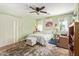 Inviting bedroom with a ceiling fan, plush carpeting, and natural light from the windows at 518 S 114Th Ave, Avondale, AZ 85323