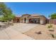 Charming single-story home with xeriscaped yard, covered porch, and convenient drive-through garage at 518 S 114Th Ave, Avondale, AZ 85323