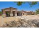 Charming single-story home with xeriscaped yard, covered porch, and convenient drive-through garage at 518 S 114Th Ave, Avondale, AZ 85323
