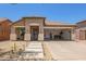 Charming single-story home with xeriscaped yard, covered porch, and convenient drive-through garage at 518 S 114Th Ave, Avondale, AZ 85323