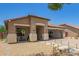 Charming single-story home with xeriscaped yard, covered porch, and convenient drive-through garage at 518 S 114Th Ave, Avondale, AZ 85323