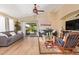 Bright and airy living room featuring wood floors, ceiling fan, and access to the outdoor patio at 518 S 114Th Ave, Avondale, AZ 85323