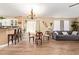 Open living and dining area features wood floors and a chandelier for an inviting space at 518 S 114Th Ave, Avondale, AZ 85323