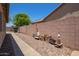 Property side yard and outdoor storage area with a walkway, gravel, and block wall at 518 S 114Th Ave, Avondale, AZ 85323