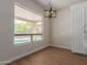Bright dining area with a modern light fixture, hardwood floors, and a view of the pool at 5330 W Folley W St, Chandler, AZ 85226