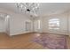 Bright and airy living room with wood floors, chandelier, and ample space for entertaining at 5330 W Folley W St, Chandler, AZ 85226