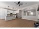 Open-concept living room and kitchen with an island, stainless appliances, and modern light fixtures at 5330 W Folley W St, Chandler, AZ 85226