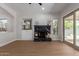 Bright living room with modern fireplace, built-in shelves, and sliding glass door to backyard at 5330 W Folley W St, Chandler, AZ 85226
