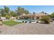 Lush backyard with a pool, patio, mature landscaping, and space for entertaining at 5410 E Poinsettia Dr, Scottsdale, AZ 85254