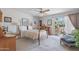 This primary bedroom features a four-poster bed and sliding glass doors to the backyard at 5410 E Poinsettia Dr, Scottsdale, AZ 85254