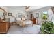 A bright primary bedroom features a four-poster bed and sliding glass doors to the backyard at 5410 E Poinsettia Dr, Scottsdale, AZ 85254