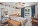 A bright bedroom features a bed with soft linens and a window letting in natural light at 5410 E Poinsettia Dr, Scottsdale, AZ 85254