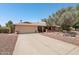 Charming single story home featuring a two-car garage, mature trees, and a well-maintained landscape at 5410 E Poinsettia Dr, Scottsdale, AZ 85254
