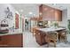 Bright kitchen with wood cabinetry, granite countertops, stainless steel appliances, and recessed lighting at 5410 E Poinsettia Dr, Scottsdale, AZ 85254
