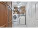 Well-lit laundry room features front loading washer and dryer, plus ample storage and folding space at 5410 E Poinsettia Dr, Scottsdale, AZ 85254