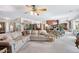 Spacious living area with a large sofa, a ceiling fan, and seamless access to the kitchen at 5410 E Poinsettia Dr, Scottsdale, AZ 85254