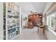A sitting room area with shelves, a leather chair, and neutral carpet is brightly lit at 5410 E Poinsettia Dr, Scottsdale, AZ 85254