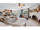 Open living space with a fireplace, a ceiling fan, and views of the backyard pool at 5410 E Poinsettia Dr, Scottsdale, AZ 85254