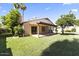 Wide view of the grassy backyard showcasing the covered patio at 5450 E Paradise Ln, Scottsdale, AZ 85254