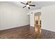 Bedroom showcasing hardwood floors, neutral walls, fan and bathroom access at 5450 E Paradise Ln, Scottsdale, AZ 85254