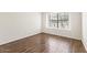 Bedroom with hardwood floors and large window providing outdoor view at 5450 E Paradise Ln, Scottsdale, AZ 85254