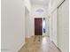 Foyer featuring a dark wood door, tile flooring, and coat closet at 5450 E Paradise Ln, Scottsdale, AZ 85254