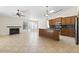 Open living room and kitchen featuring tile floors and fireplace at 5450 E Paradise Ln, Scottsdale, AZ 85254