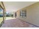 View of the covered patio with tile flooring, with a large window at 5450 E Paradise Ln, Scottsdale, AZ 85254