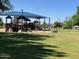 Community playground featuring multiple play structures and shaded seating areas at 5450 E Paradise Ln, Scottsdale, AZ 85254
